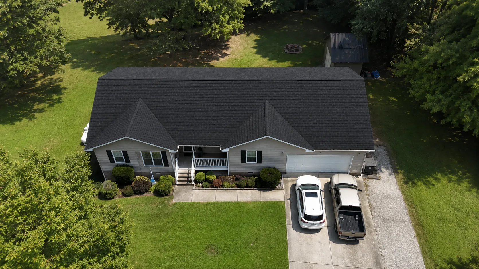 The same single-story home from above, now with a new, uniform dark charcoal shingle roof