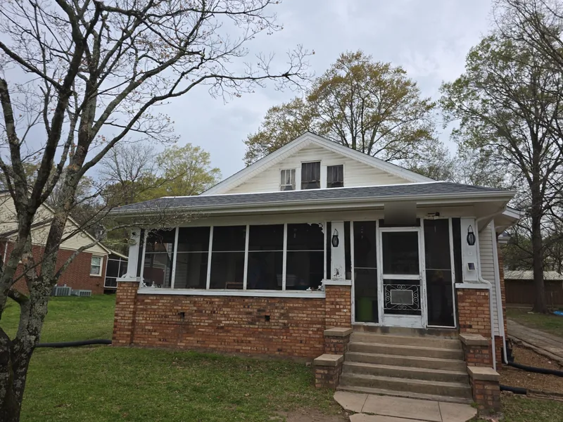 Bungalow with a screened porch in Paris, TN with its new gray architectural shingle roof
