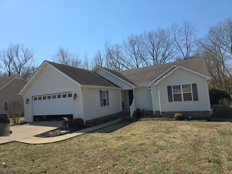 Ranch home with an attached garage in Paris, TN with its weathered shingle roof, before replacement