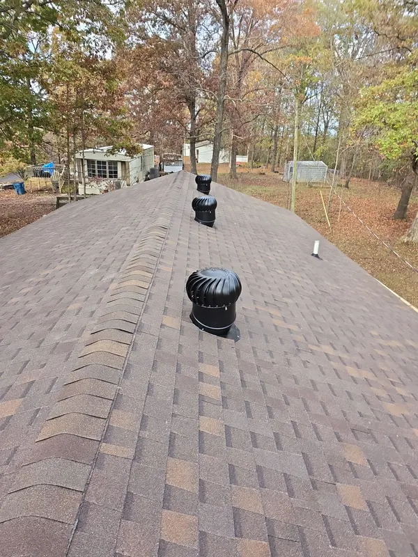 New architectural shingle roof with ridge cap and turbine vents in Calvert City, KY
