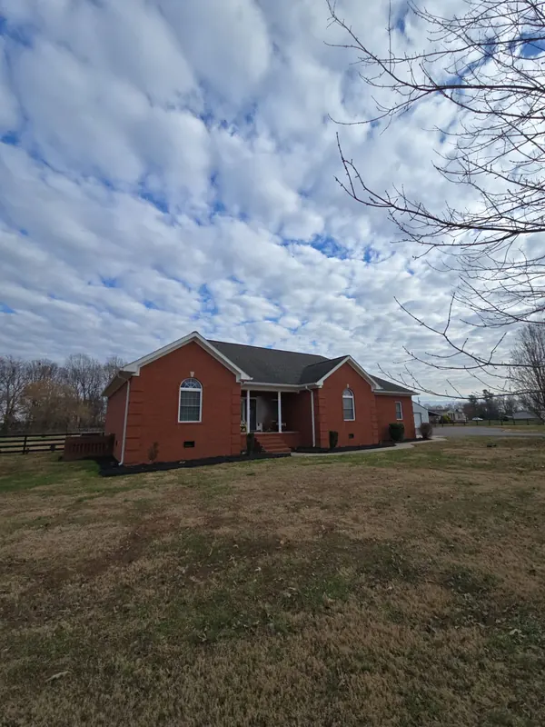 Brick ranch home in Benton, KY with a dark architectural shingle roof